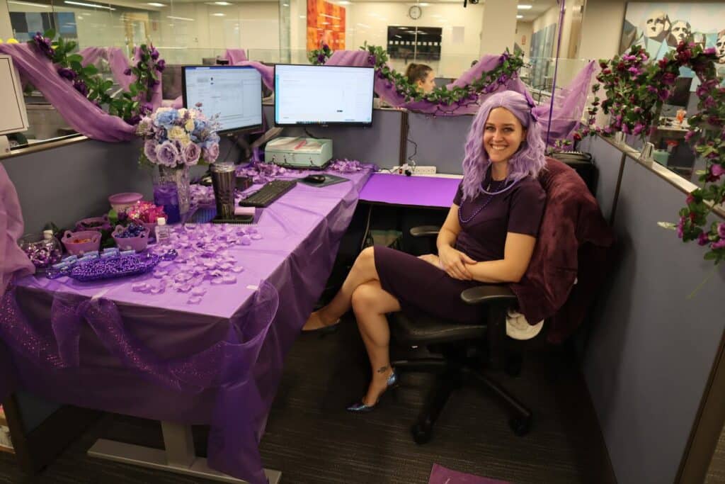 Desk decorated in purple for Color Day during Spirit Week.