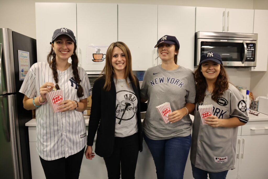 Madison Trust employees dressed up in Yankees jersey on Team Day during Spirit Week.
