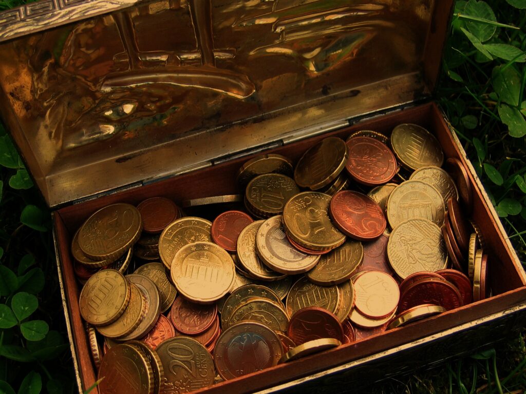 A mix of coins in a metal box