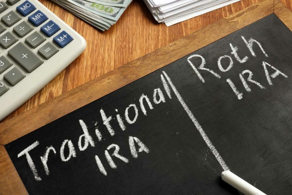 Chalkboard with Traditional IRA on one side and Roth IRA on the other to display the conversion of retirement funds from a Traditional IRA to a Roth IRA.