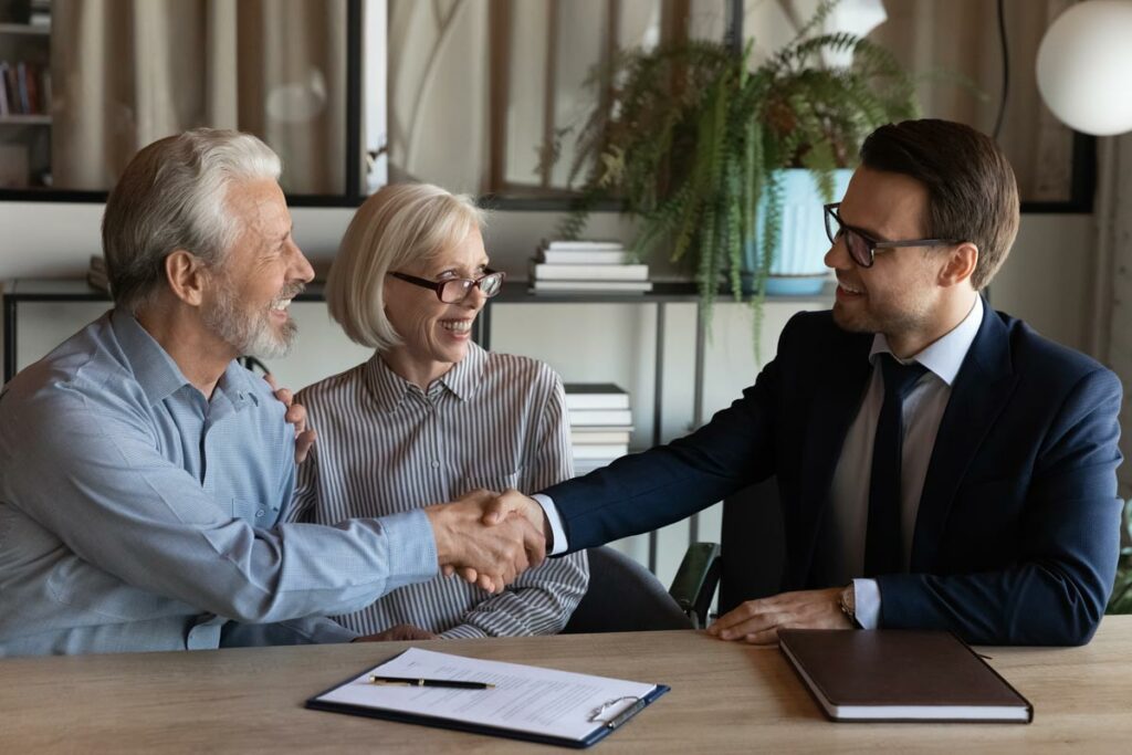 Self-Directed IRA investors meeting with a Self-Directed IRA Specialist and shaking hands to indicate that Self-Directed IRA Specialists are here to answer your self-directed investing questions.