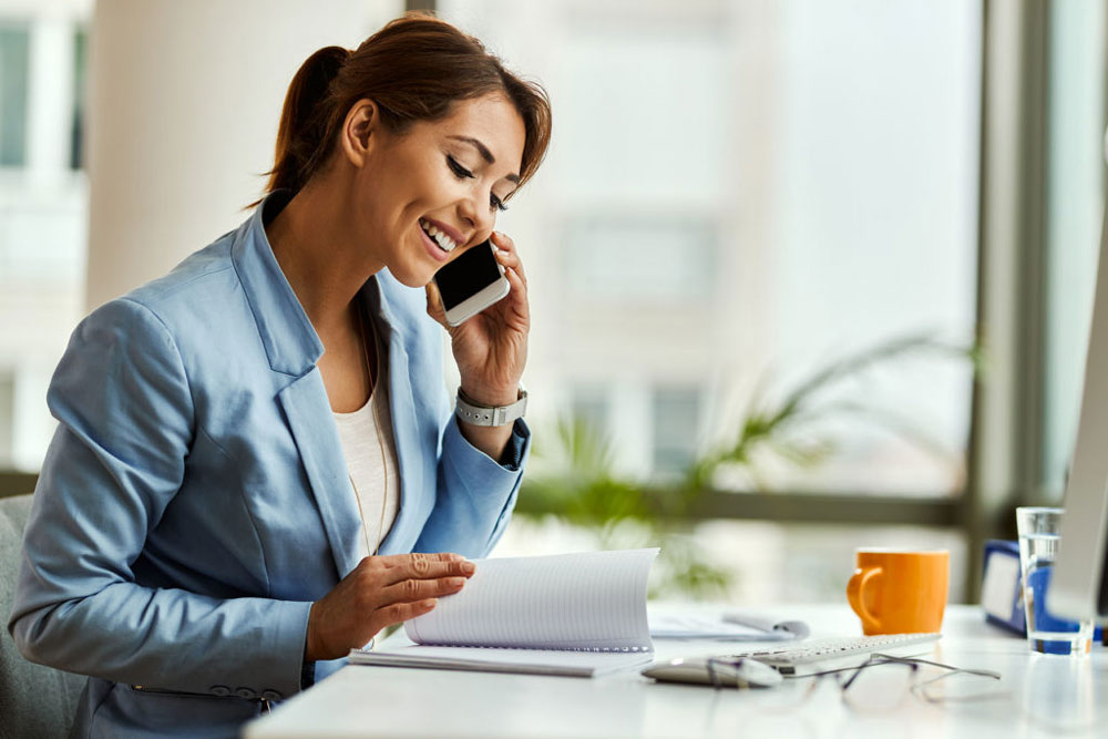 Young woman investor on the phone speaking with a Self-Directed IRA Specialist, tax or financial advisor.