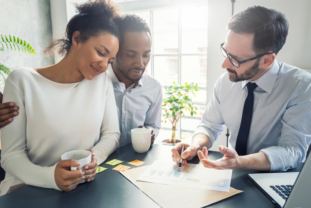 Self-Directed IRA Specialist explaining investing in alternative assets to a couple.