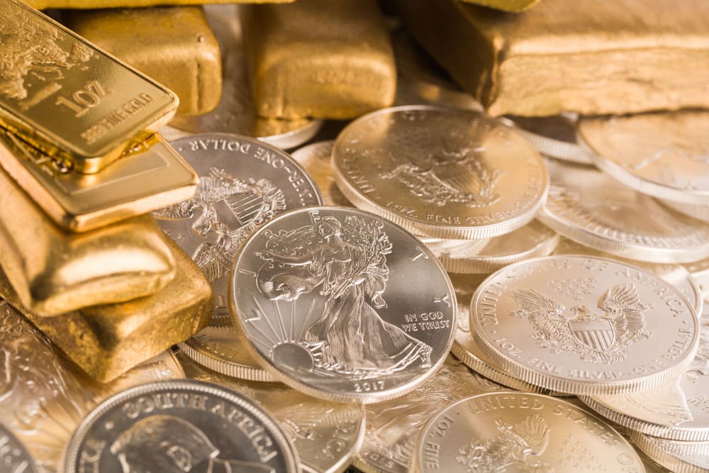 Pile of gold and silver bullion, which can be invested in with a Self-Directed IRA.