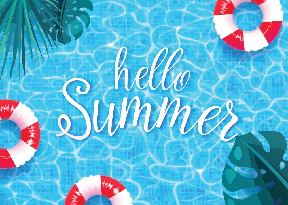 Pool with tropical palm trees and plants and floats with “Hello Summer” written in script in the center.