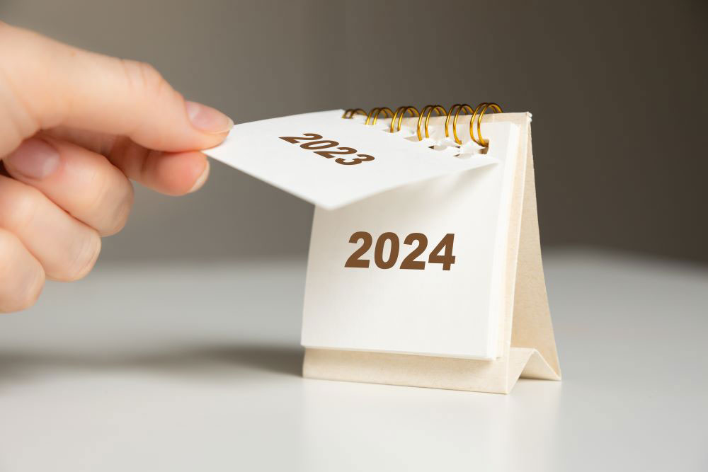 Investor turning the calendar from 2023 to 2024 to signify the new year and all of the Self-Directed IRA checklist items needed to be accomplished to maximize their retirement savings in the new year.