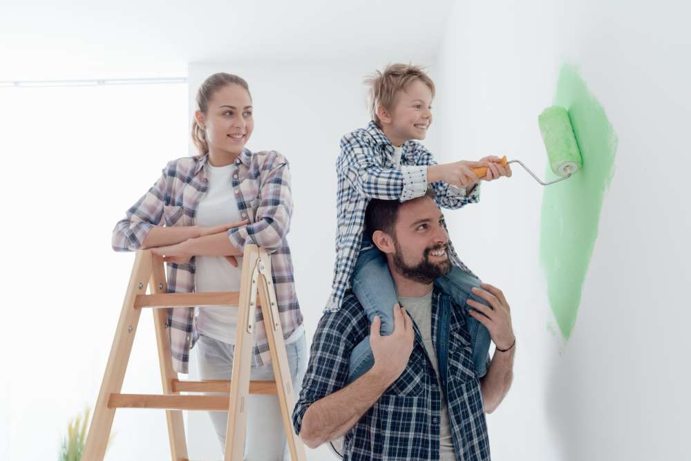 A happy family repaints the walls of the home they inherited and claimed as their own, all through in-kind distributions. 