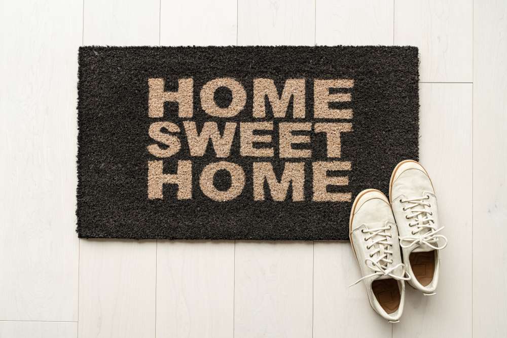 A welcome mat reading “Home Sweet Home” awaiting its investors who’ve used in-kind distributions to turn their real estate investment into their personal home. 
