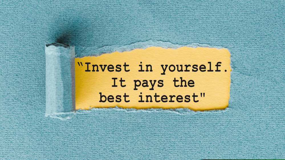 A strip of paper is ripped and reeled back to reveal the phrase, “Invest in yourself. It pays the best interest.”