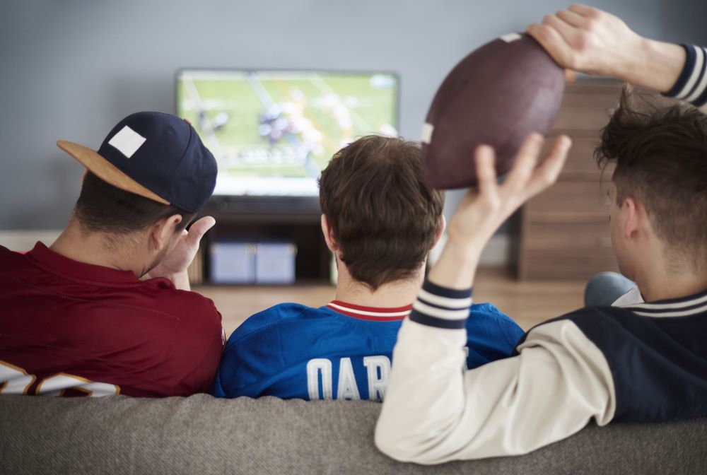 football fans watching super bowl commercials