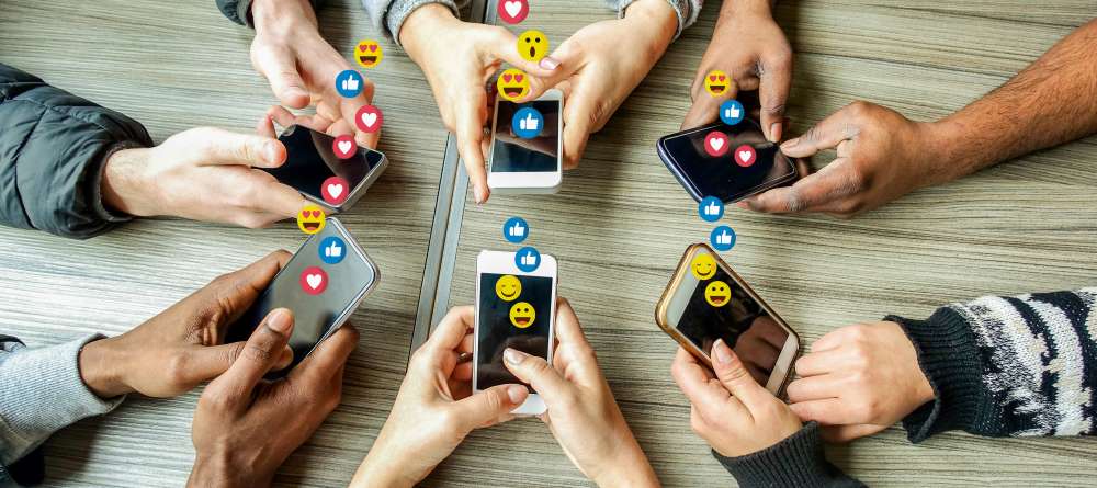 Users in a circle all on their phones engaging on social media.