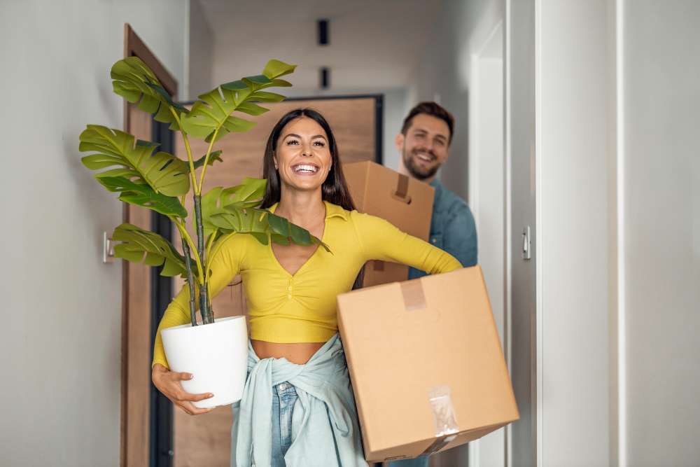 A happy couple unpacks their belongings in their new home, all made possible by their diversified portfolio and increase in income from their Bluestone investment.
