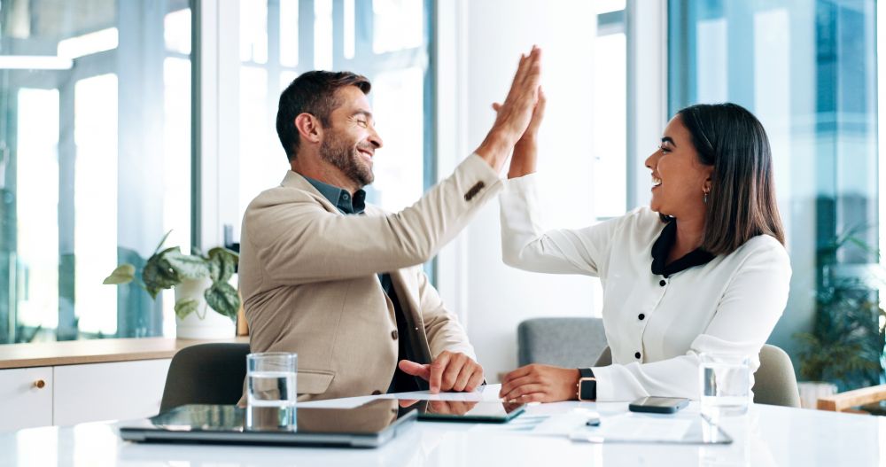 Two eager investors high-five after comparing Self-Directed SEP IRAs with Self-Directed Roth IRAs.